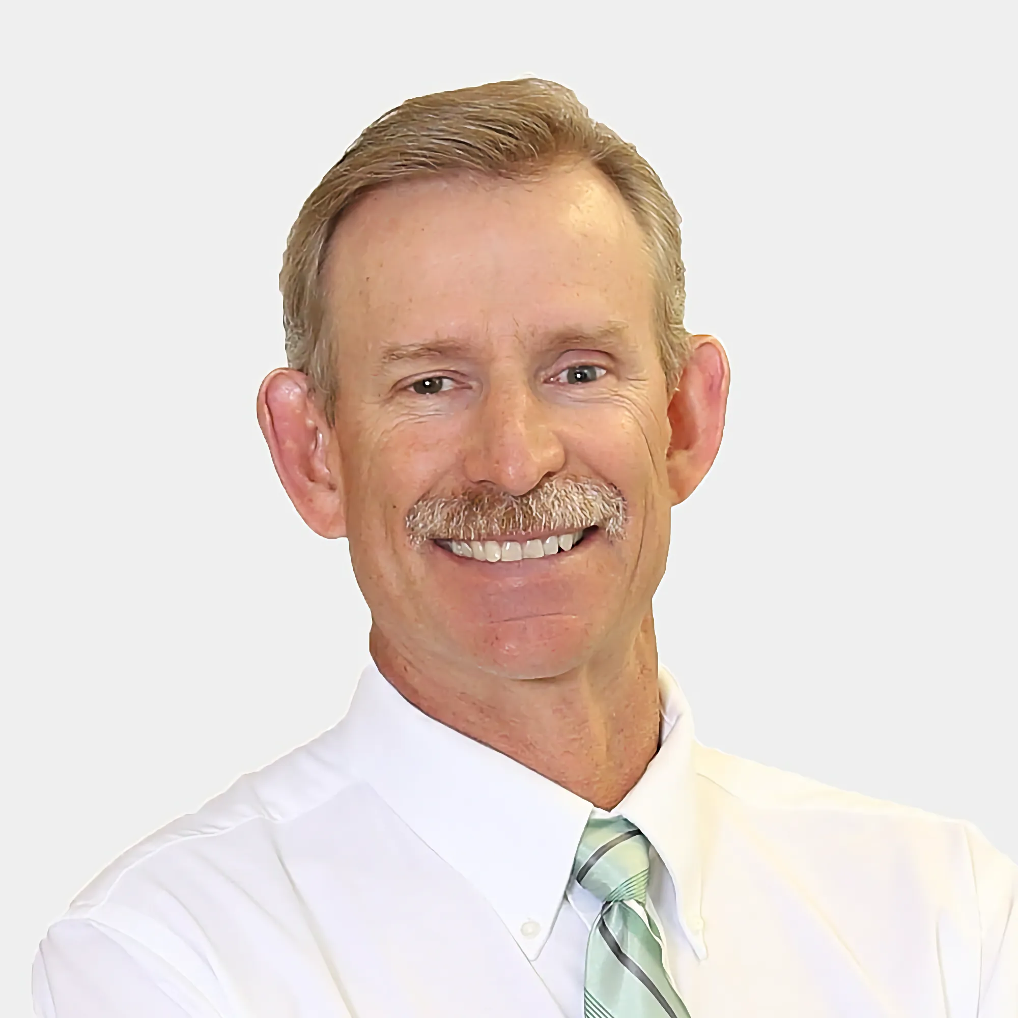 Chris Love, Owner and Residential Mortgage Loan Originator, with a mustache, smiles warmly in a white shirt and light green patterned tie.
